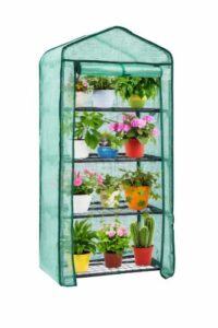 Four-tier mini greenhouse with green mesh cover holding potted plants on a compact metal rack