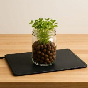 Black 9x19.5-inch Hydrofarm seedling heat mat used for hydroponic microgreen germination.